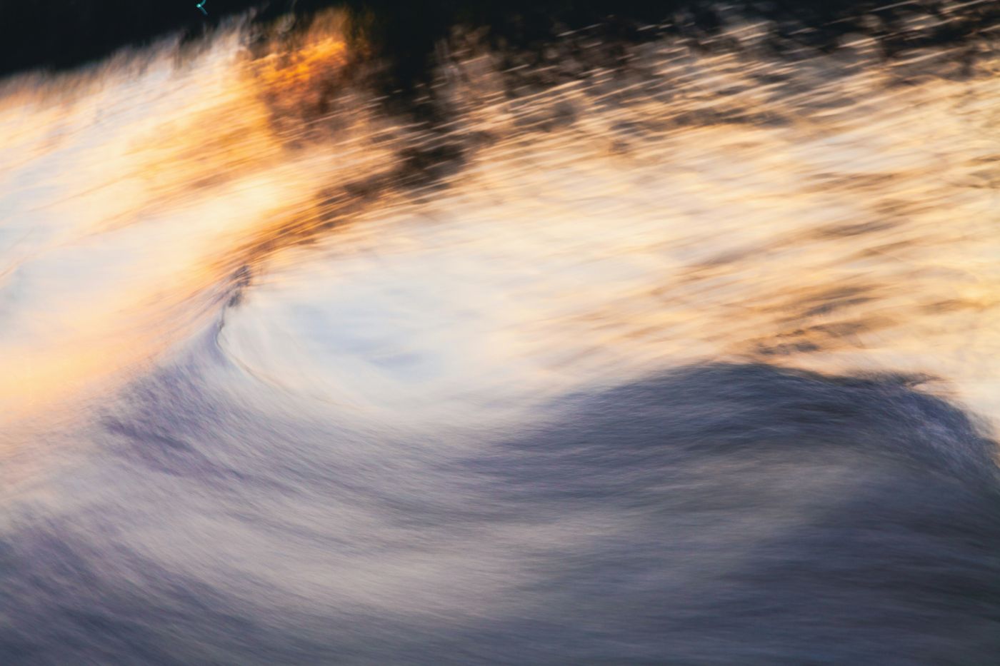 Moving water with golden reflections