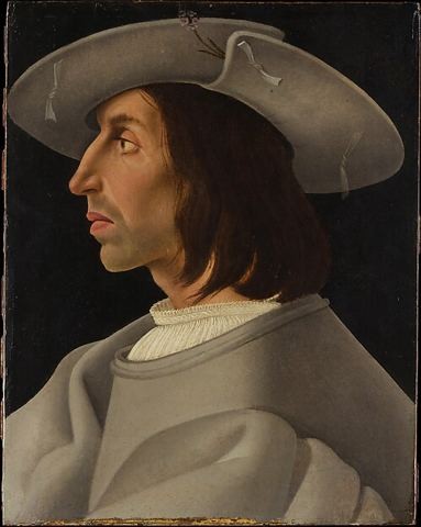 A man in profile in a broad grey hat